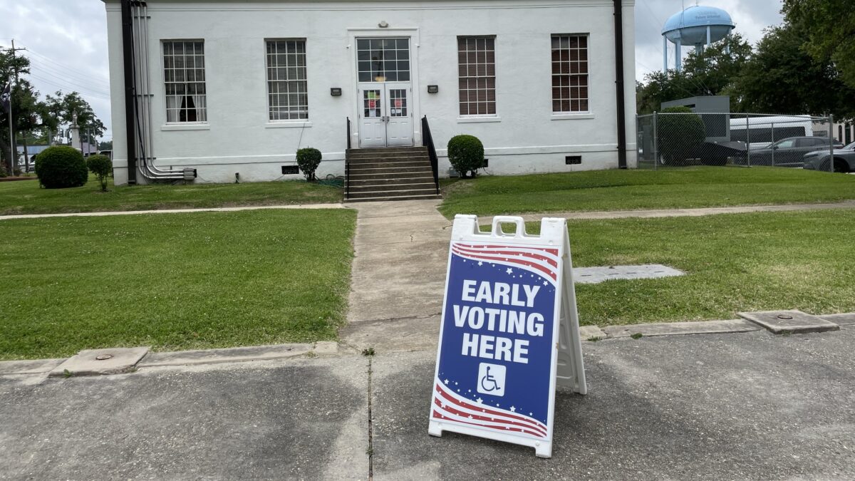 Early Voting Here sign on a sidewalk outside the Madison Parish Courthouse in Tallulah, Louisiana.