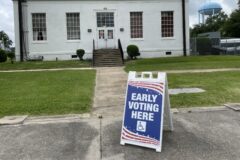 Early Voting Here sign on a sidewalk outside the Madison Parish Courthouse in Tallulah, Louisiana.
