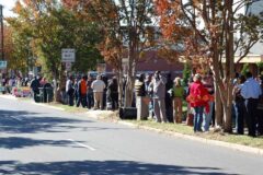Voters line up along a tree-lined street in Charlotte, North Carolina, to vote early at a public library in 2008.