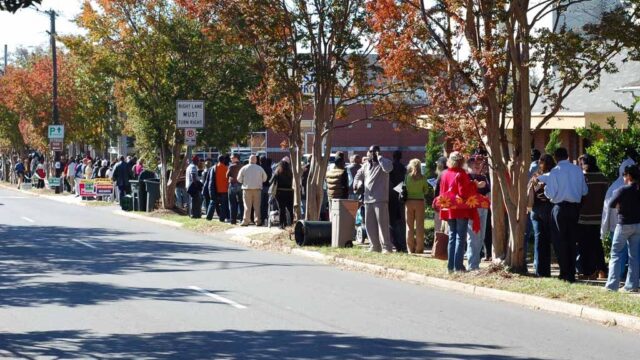 Voters line up along a tree-lined street in Charlotte, North Carolina, to vote early at a public library in 2008.