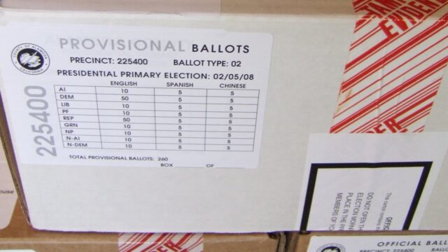 A cardboard box labeled Provisional Ballots, with a precinct number and a ballot count table, sealed with red tamper-evident tape.