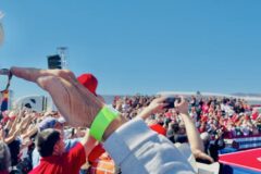 Sen. Wendy Rogers at President Trump's rally in Bullhead City, Arizona, on Oct. 14, 2026, with Trump on stage and a packed crowd behind them.