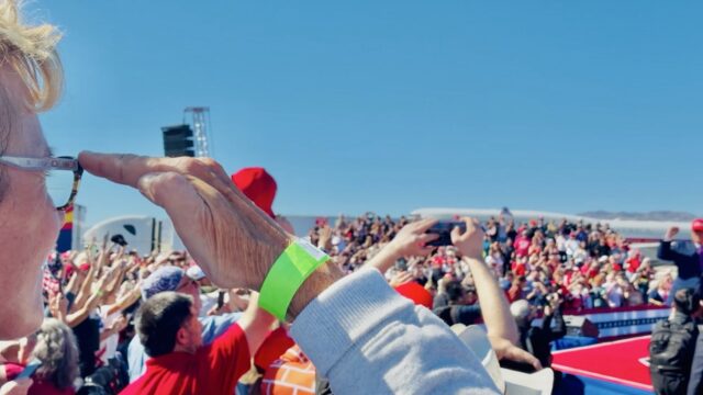 Sen. Wendy Rogers at President Trump's rally in Bullhead City, Arizona, on Oct. 14, 2026, with Trump on stage and a packed crowd behind them.